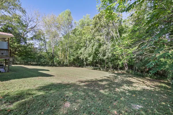 a pathway of a house with a yard