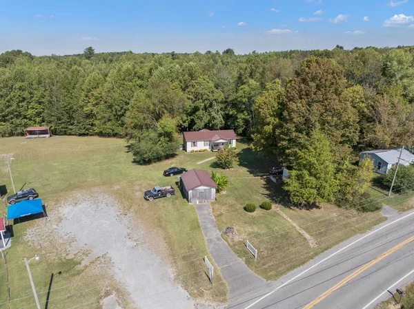 an aerial view of a house with a yard