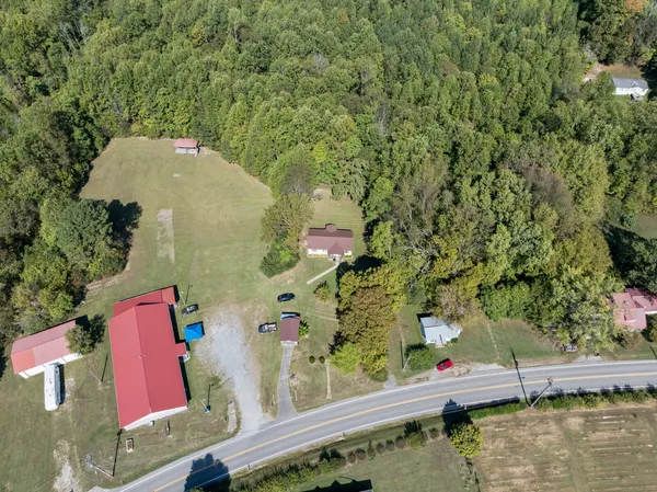 an aerial view of a house a yard and mountain view in back