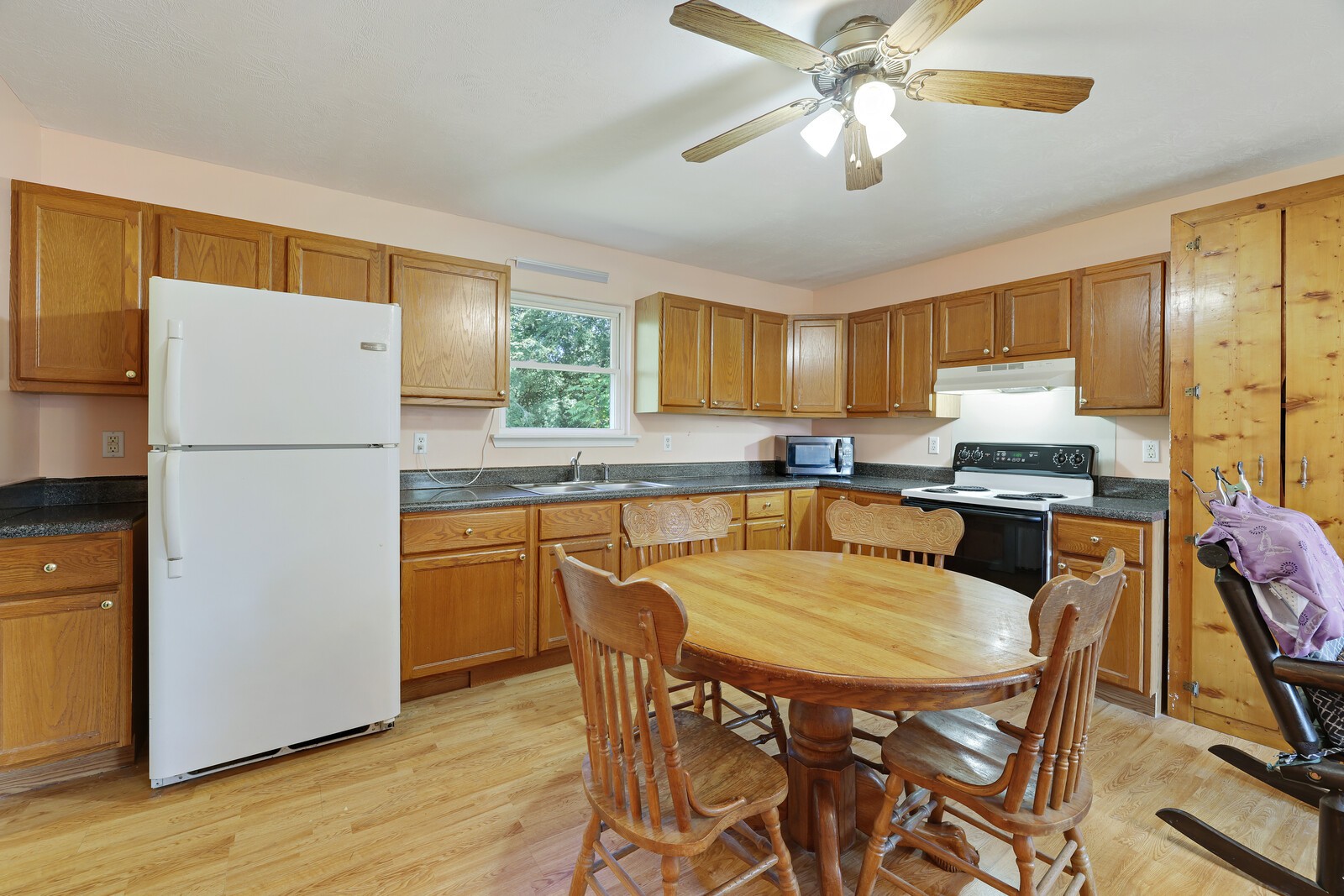 634 Bennett Hill Road Red Boiling Springs, TN 37150 - Photo 9 of 44 a kitchen with granite countertop a refrigerator a stove a sink dishwasher a dining table and chairs with wooden floor