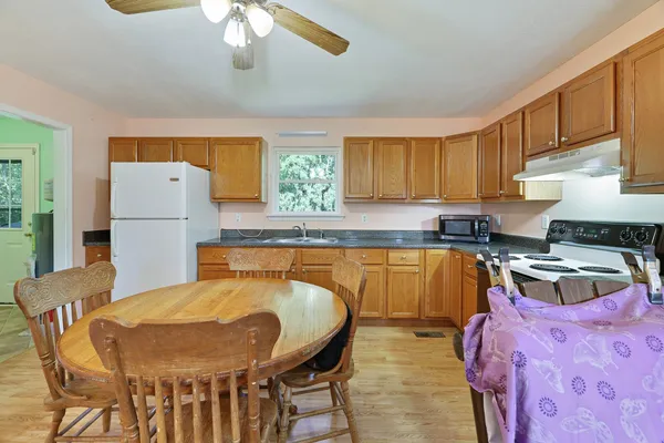 a kitchen with granite countertop cabinets stainless steel appliances and a counter space