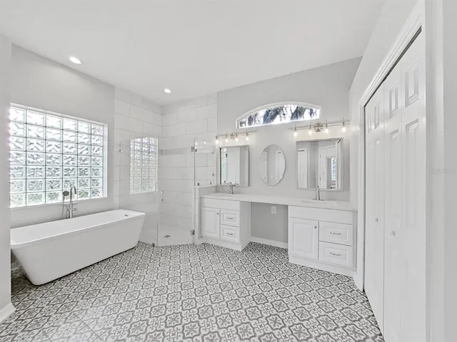 a bathroom with a bathtub sink and mirror