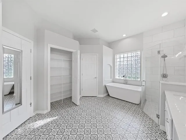 a bathroom with a bathtub and a shower