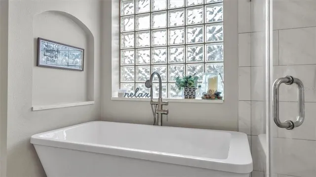 a white bath tub sitting next to a window