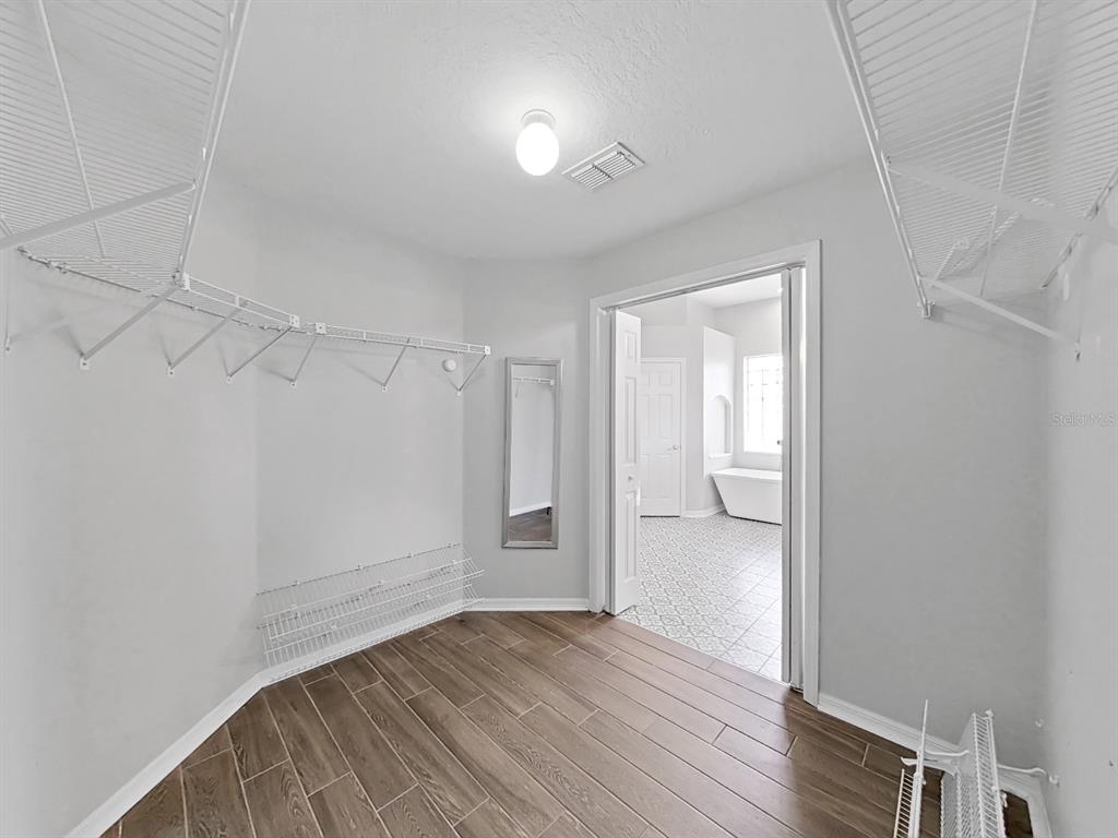 3307 Kilmer Place Plant City, FL 33566 - Photo 20 of 32 a view of an empty room with wooden floor and a window