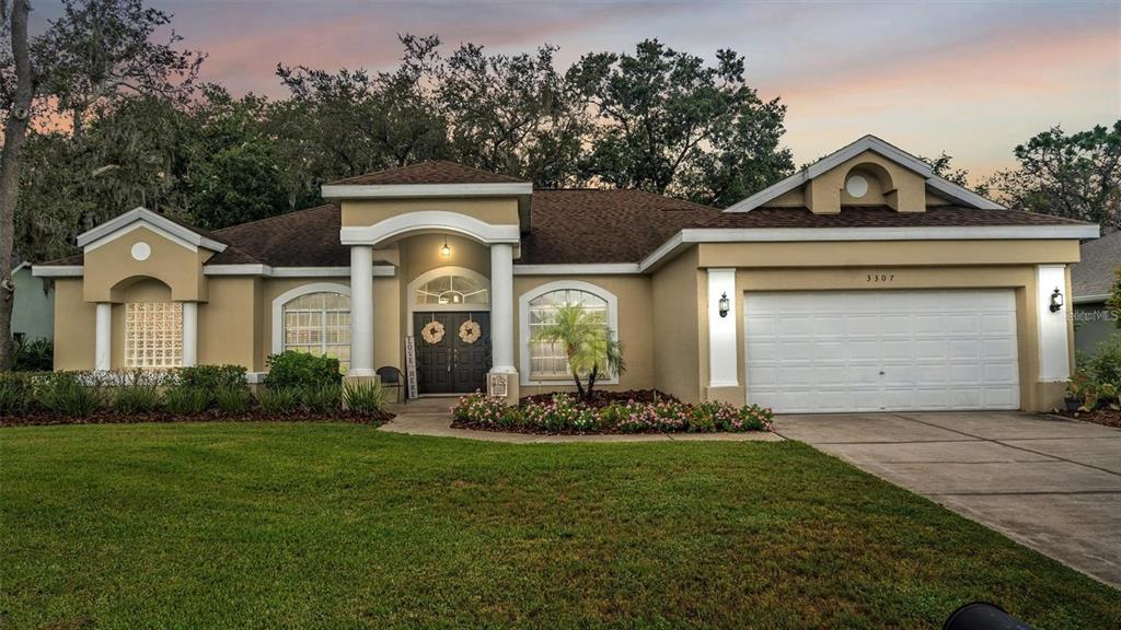 3307 Kilmer Place Plant City, FL 33566 - Photo 2 of 32 a front view of a house with a yard