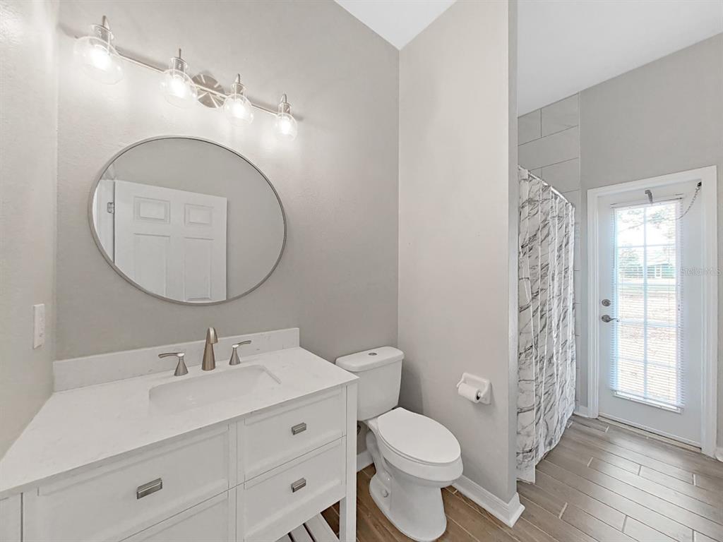 3307 Kilmer Place Plant City, FL 33566 - Photo 22 of 32 a bathroom with a toilet a sink and mirror