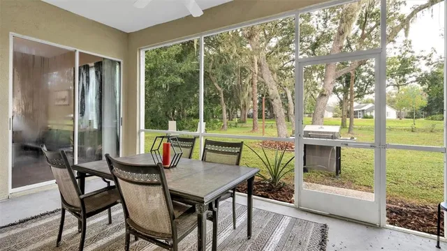 a view of a patio with a table chairs and a backyard