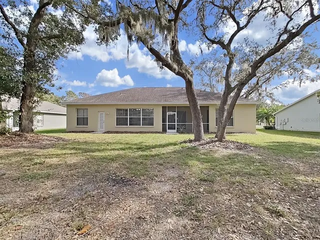 a house that has a tree in front of it
