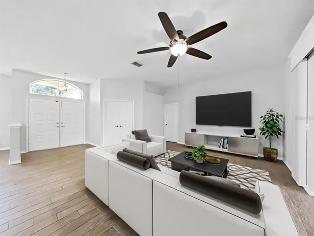 a living room with furniture and a flat screen tv
