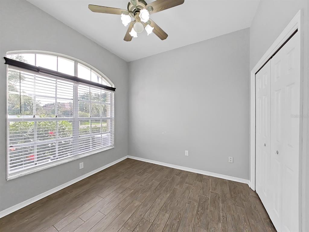 3307 Kilmer Place Plant City, FL 33566 - Photo 7 of 32 a view of an empty room with a window and wooden floor