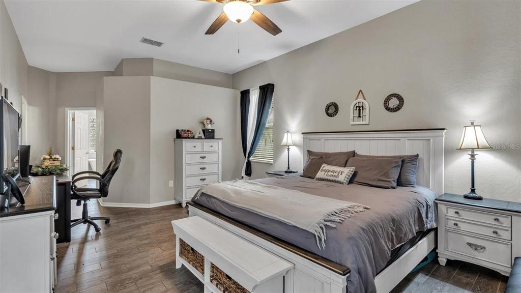 3307 Kilmer Place Plant City, FL 33566 - Photo 8 of 32 a bedroom with a bed and a chandelier