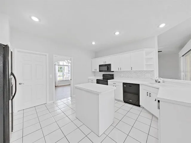 a kitchen with stainless steel appliances a refrigerator sink and cabinets