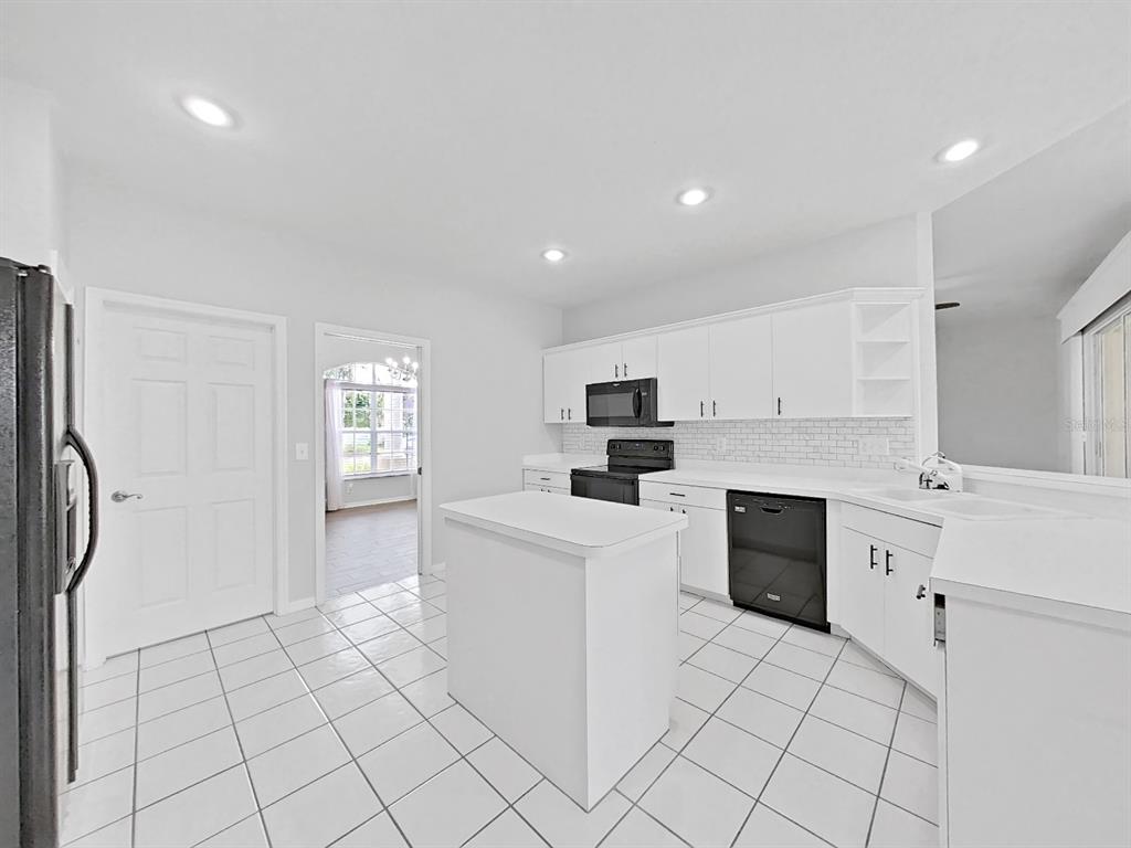 3307 Kilmer Place Plant City, FL 33566 - Photo 10 of 32 a kitchen with stainless steel appliances a refrigerator sink and cabinets