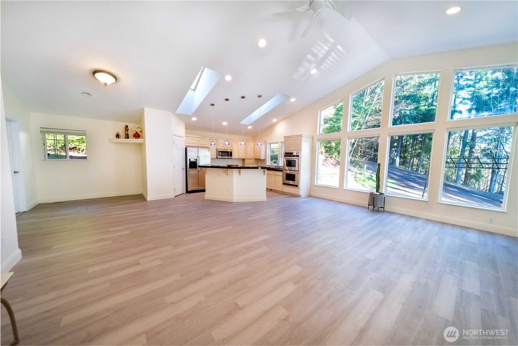 118 Clark Creek Road Longview, WA 98632 - Photo 12 of 19 an empty room with wooden floor and large windows