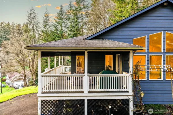 a porch with a bench next to a yard