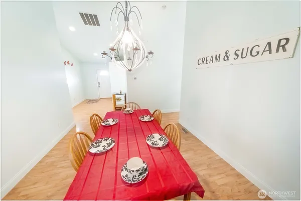 a kitchen with kitchen island white cabinets and stainless steel appliances