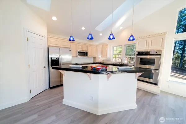 a kitchen with granite countertop a sink and cabinets