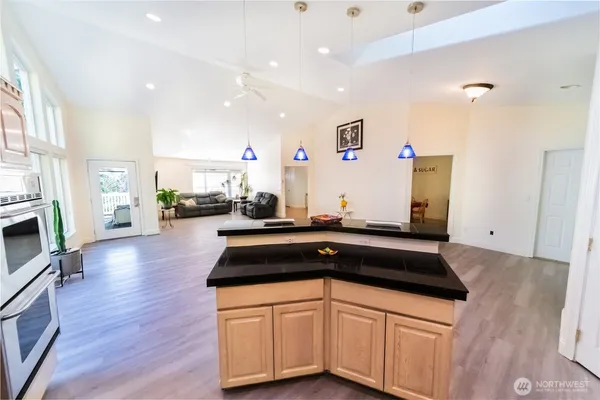 a living room with furniture and large windows