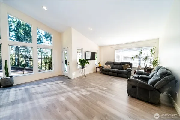 a view of a kitchen with a sink wooden floor and a large window