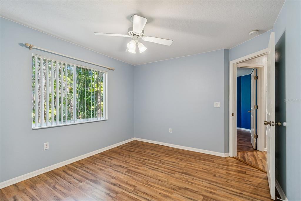 6070 Drexel Road Land O' Lakes, FL 34638 - Photo 12 of 23 a view of an empty room with wooden floor and a window