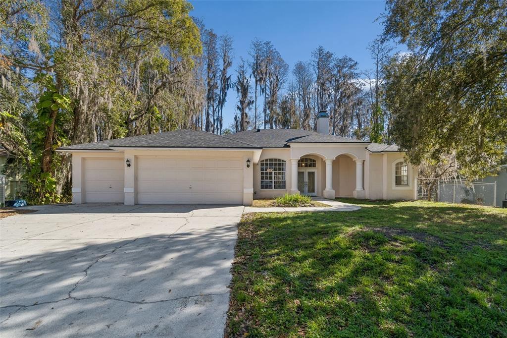 6070 Drexel Road Land O' Lakes, FL 34638 - Photo 2 of 23 a view of a house with backyard and trees