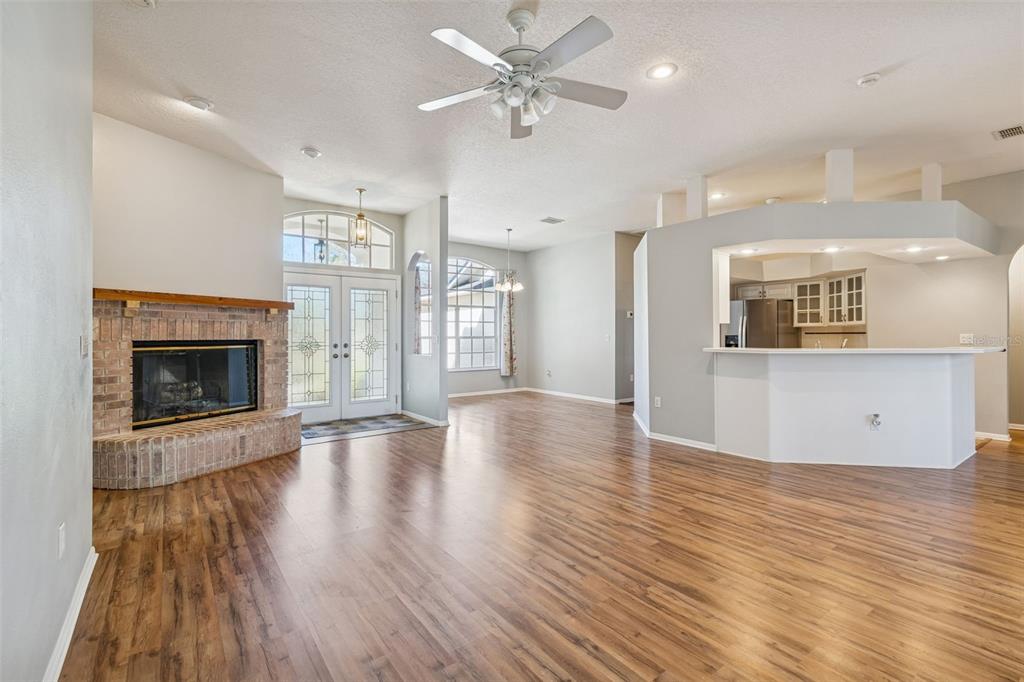 6070 Drexel Road Land O' Lakes, FL 34638 - Photo 4 of 23 an empty room with wooden floor and a fireplace