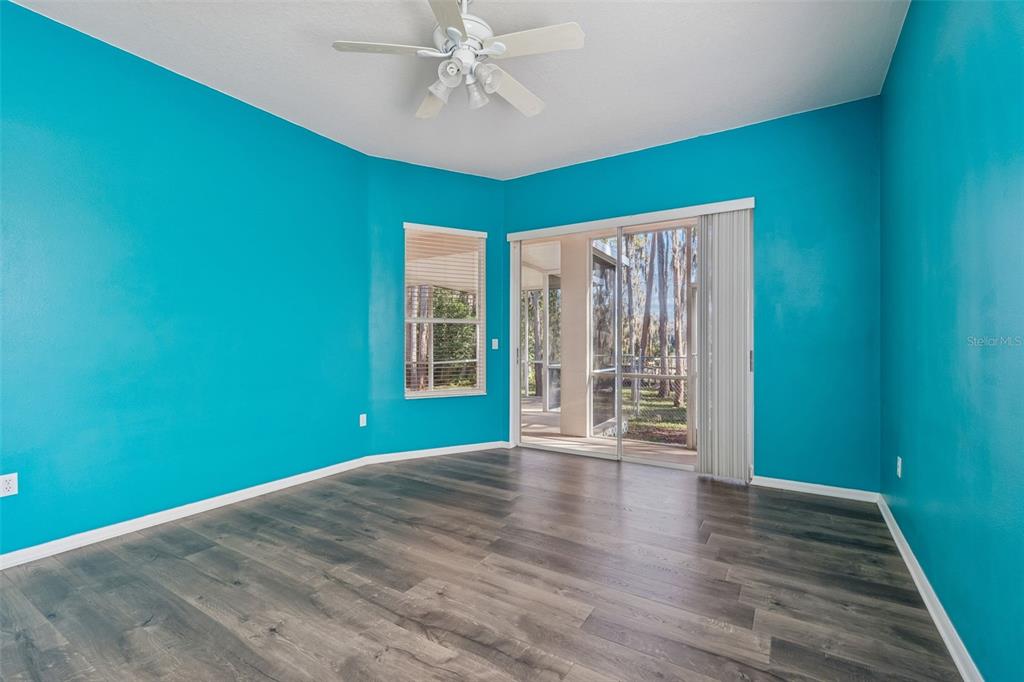 6070 Drexel Road Land O' Lakes, FL 34638 - Photo 8 of 23 a view of an empty room with a window and wooden floor