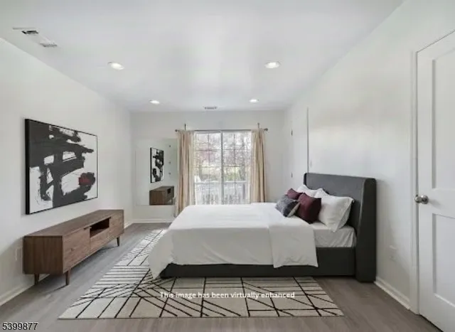 a bedroom with a bed and glass windows