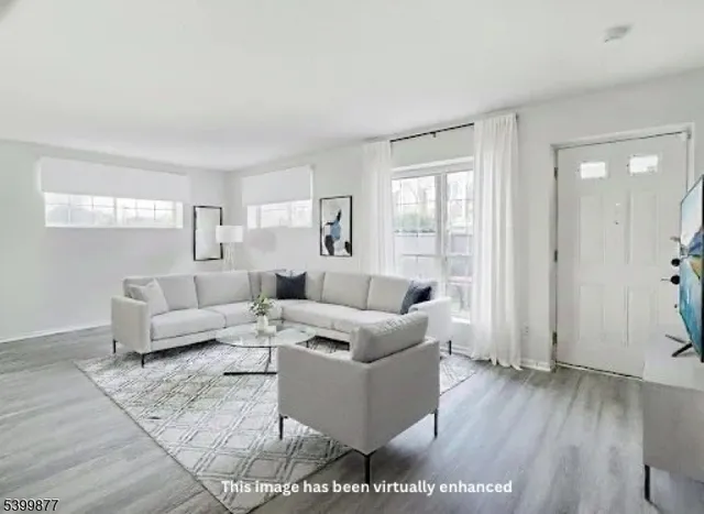 a living room with furniture and wooden floor