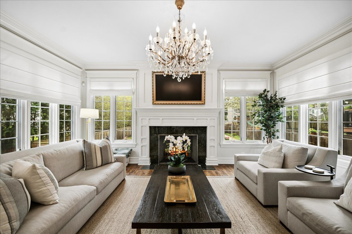 556 Willow Road Winnetka, IL 60093 - Photo 19 of 43 a living room with furniture a flat screen tv and a fireplace