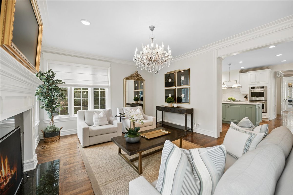 556 Willow Road Winnetka, IL 60093 - Photo 20 of 43 a living room with furniture or chandelier and a fireplace