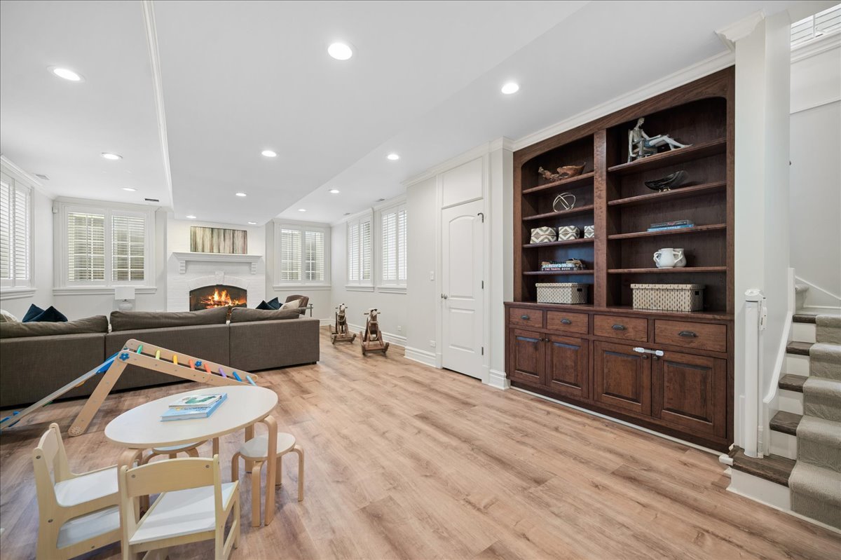 556 Willow Road Winnetka, IL 60093 - Photo 35 of 43 a living room with furniture a dining table and chairs with wooden floor