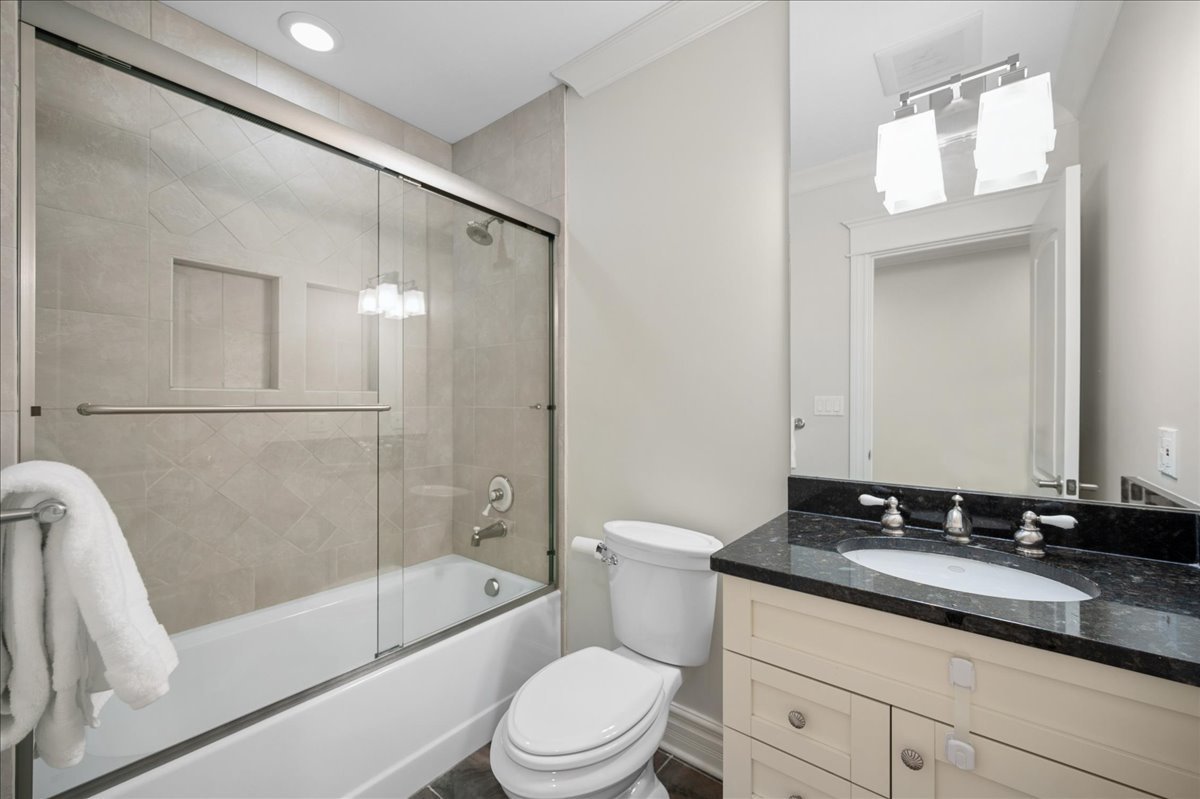 556 Willow Road Winnetka, IL 60093 - Photo 38 of 43 a bathroom with a bathtub shower sink vanity mirror and toilet