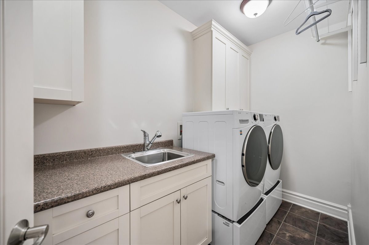 556 Willow Road Winnetka, IL 60093 - Photo 39 of 43 a utility room with sink dryer and washer
