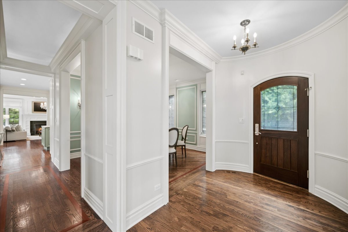 556 Willow Road Winnetka, IL 60093 - Photo 4 of 43 wooden floor in an empty room with a window
