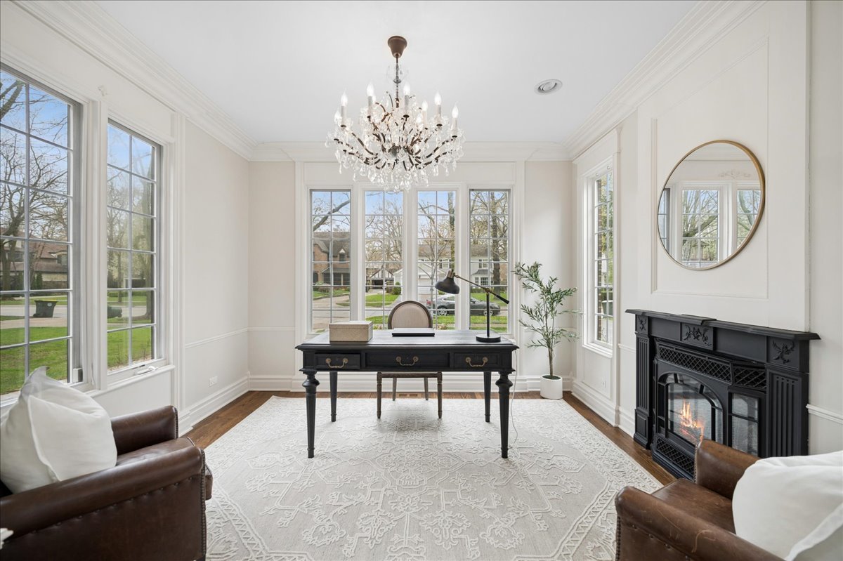 556 Willow Road Winnetka, IL 60093 - Photo 7 of 43 a living room with furniture a fireplace and a large window