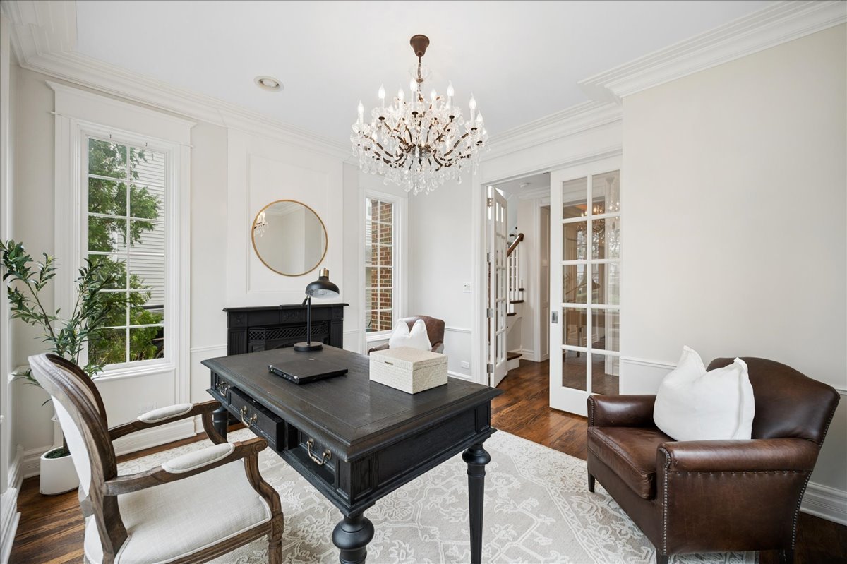 556 Willow Road Winnetka, IL 60093 - Photo 8 of 43 a living room with furniture a chandelier and a fireplace