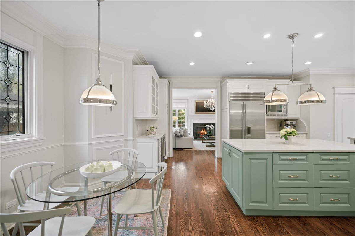 556 Willow Road Winnetka, IL 60093 - Photo 10 of 43 a kitchen with stainless steel appliances kitchen island granite countertop a kitchen island hardwood floor and a sink