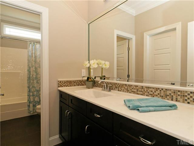 2101 Morrocroft Drive Raleigh, NC 27615 - Photo 19 of 22 One Of Two Spacious Guest Bathrooms. Custom Tiled Back Splash And Lots Of Counter And Mirror Space. Bathroom