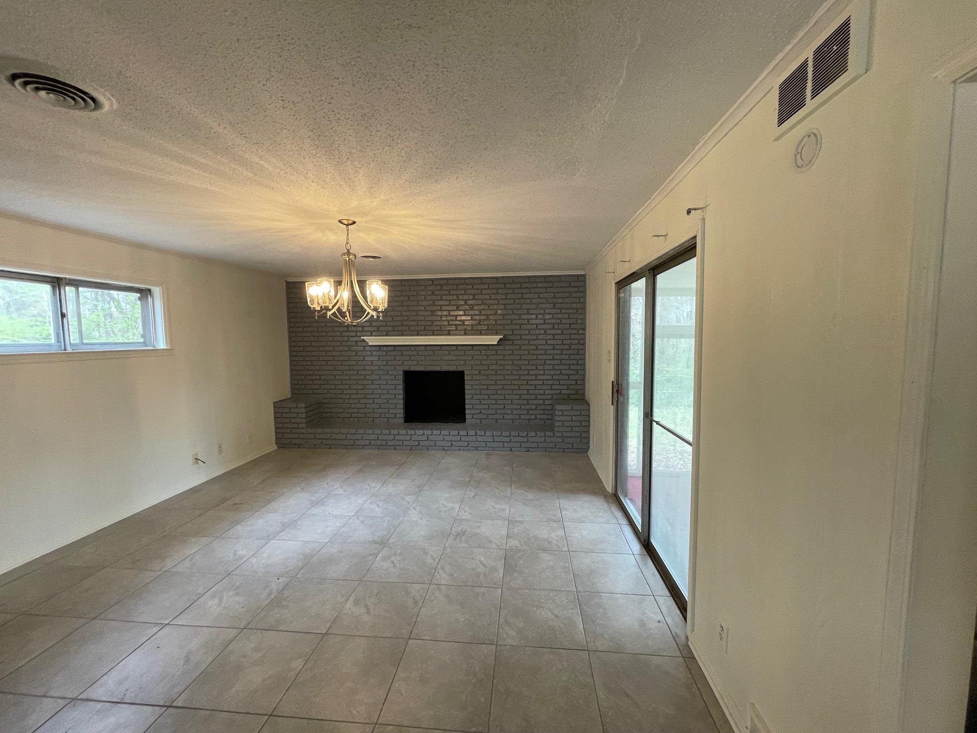 1898 Pennel Road Memphis, TN 38116 - Photo 11 of 34 a view of a big room with windows and chandelier