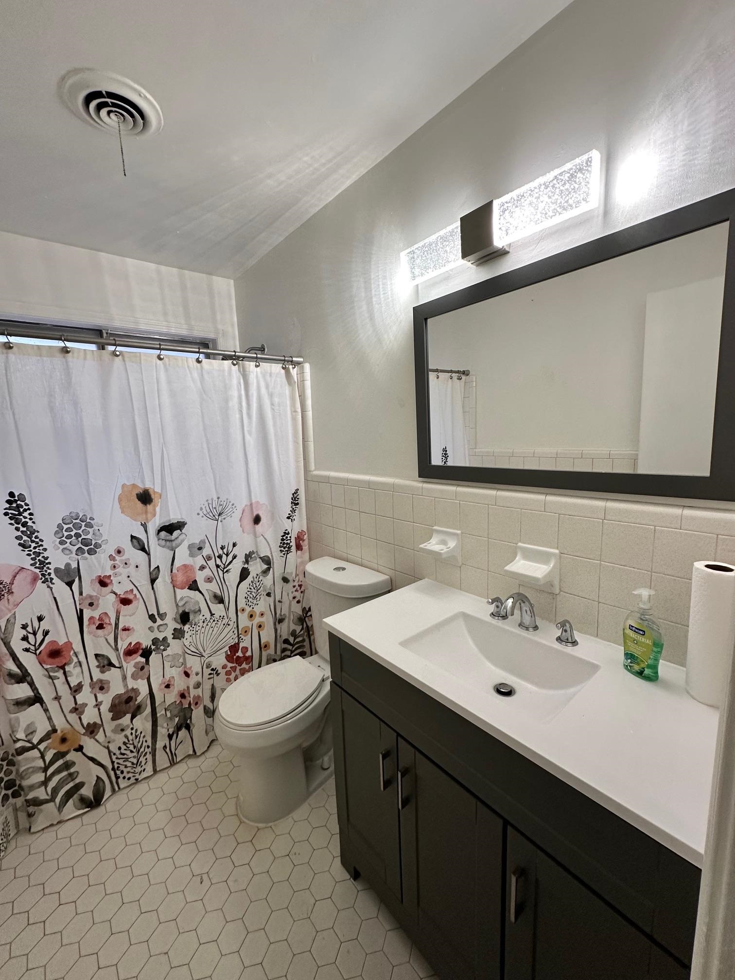 1898 Pennel Road Memphis, TN 38116 - Photo 12 of 34 a bathroom with a toilet sink and mirror