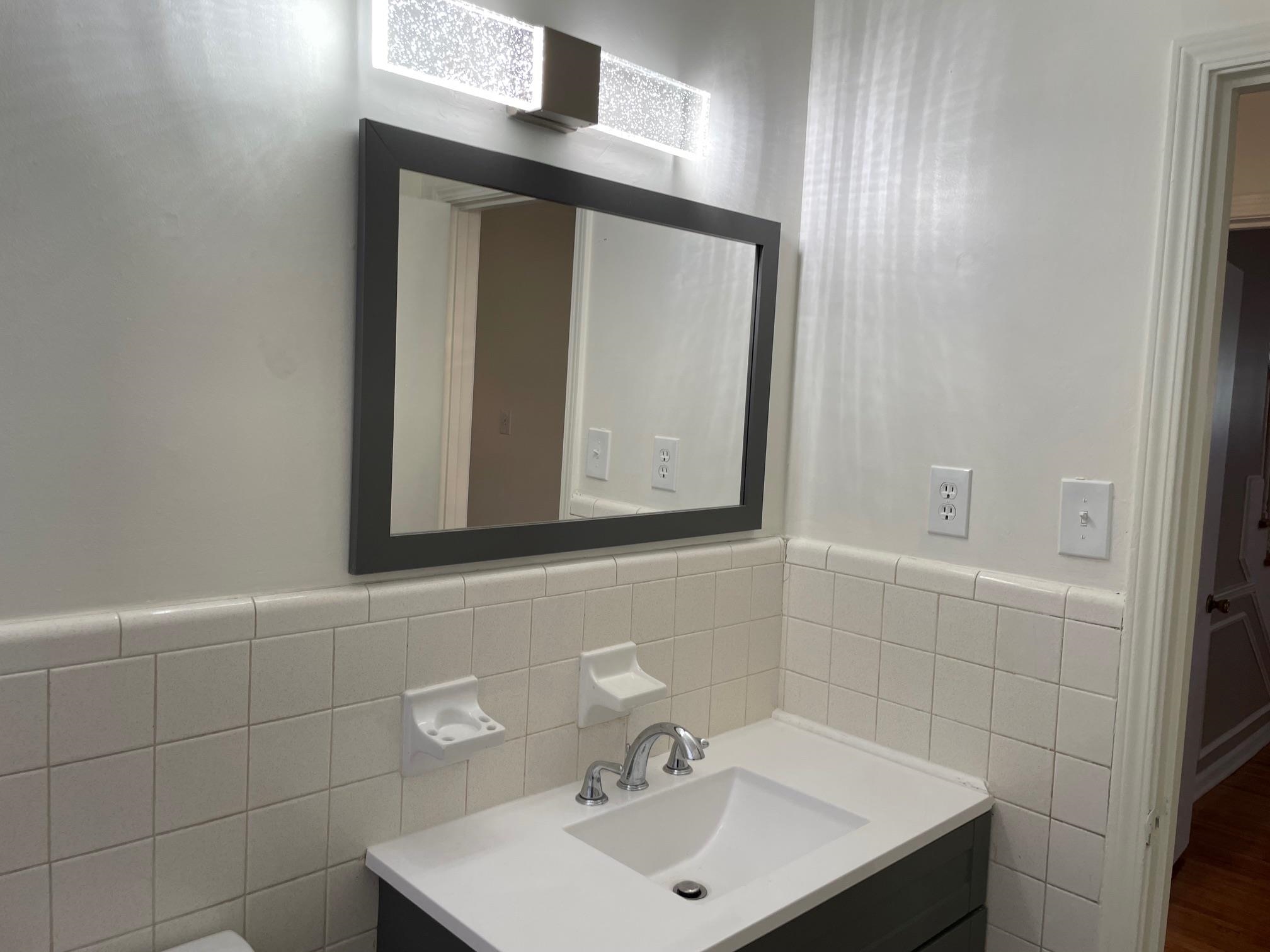 1898 Pennel Road Memphis, TN 38116 - Photo 13 of 34 a bathroom with a sink and a mirror