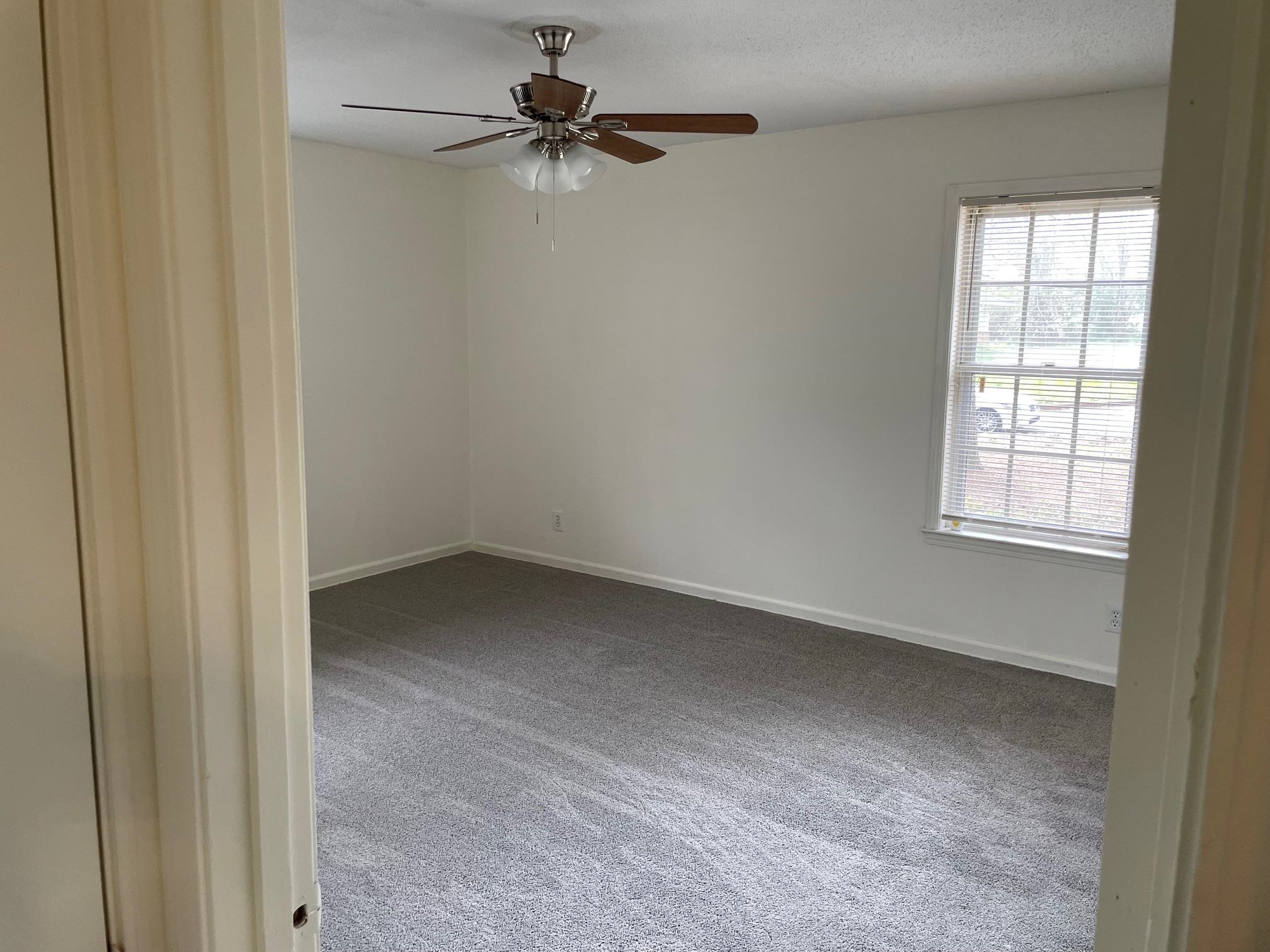 1898 Pennel Road Memphis, TN 38116 - Photo 15 of 34 an empty room with a window and a fan