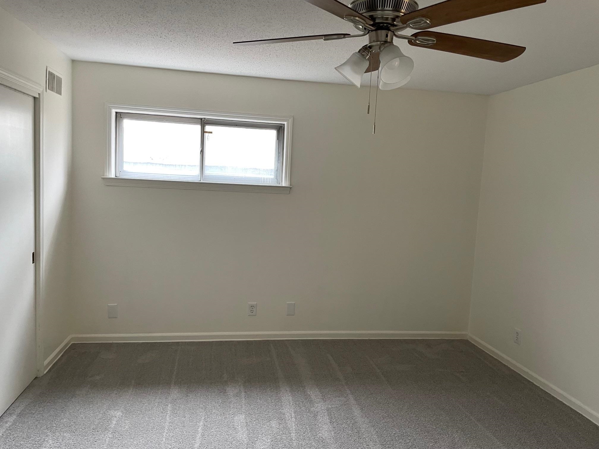 1898 Pennel Road Memphis, TN 38116 - Photo 16 of 34 an empty room with a window and a fan