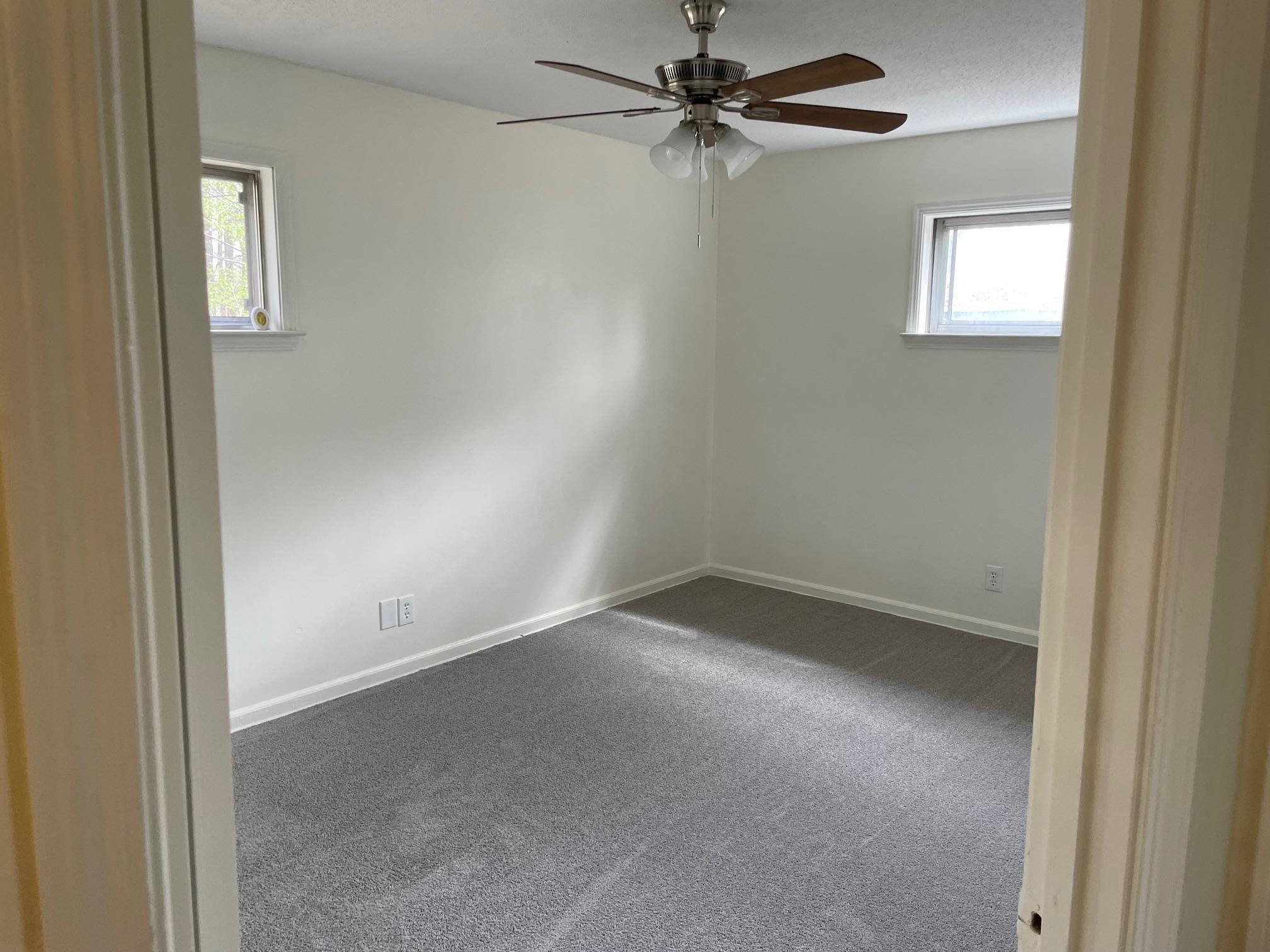 1898 Pennel Road Memphis, TN 38116 - Photo 17 of 34 an empty room with a window and a fan