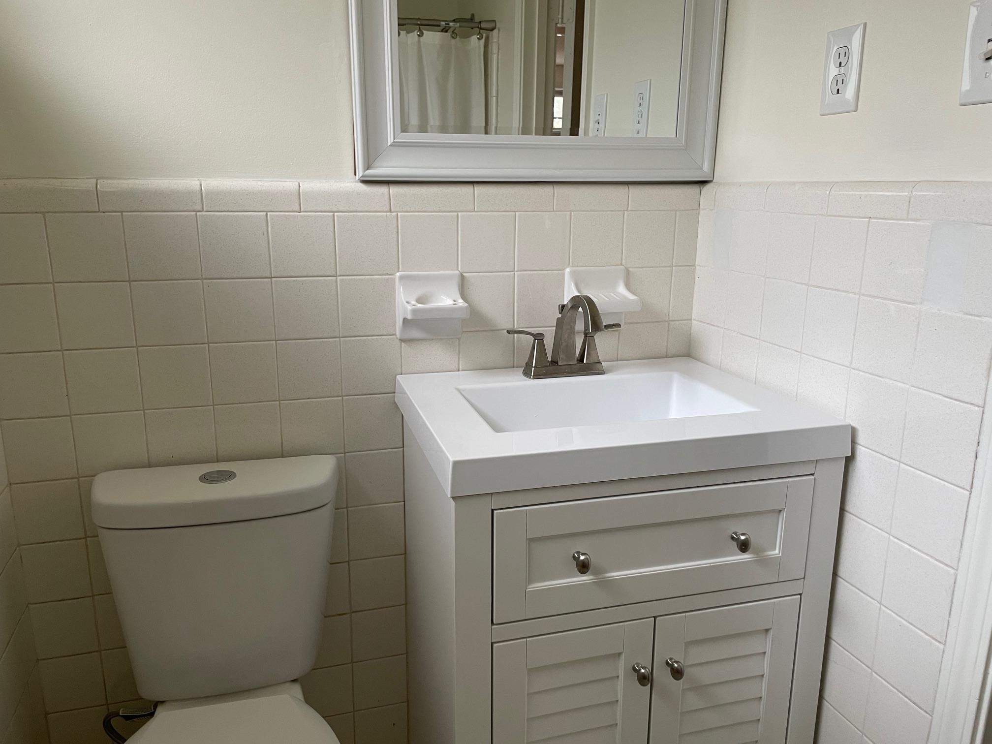 1898 Pennel Road Memphis, TN 38116 - Photo 23 of 34 a bathroom with a toilet sink and mirror