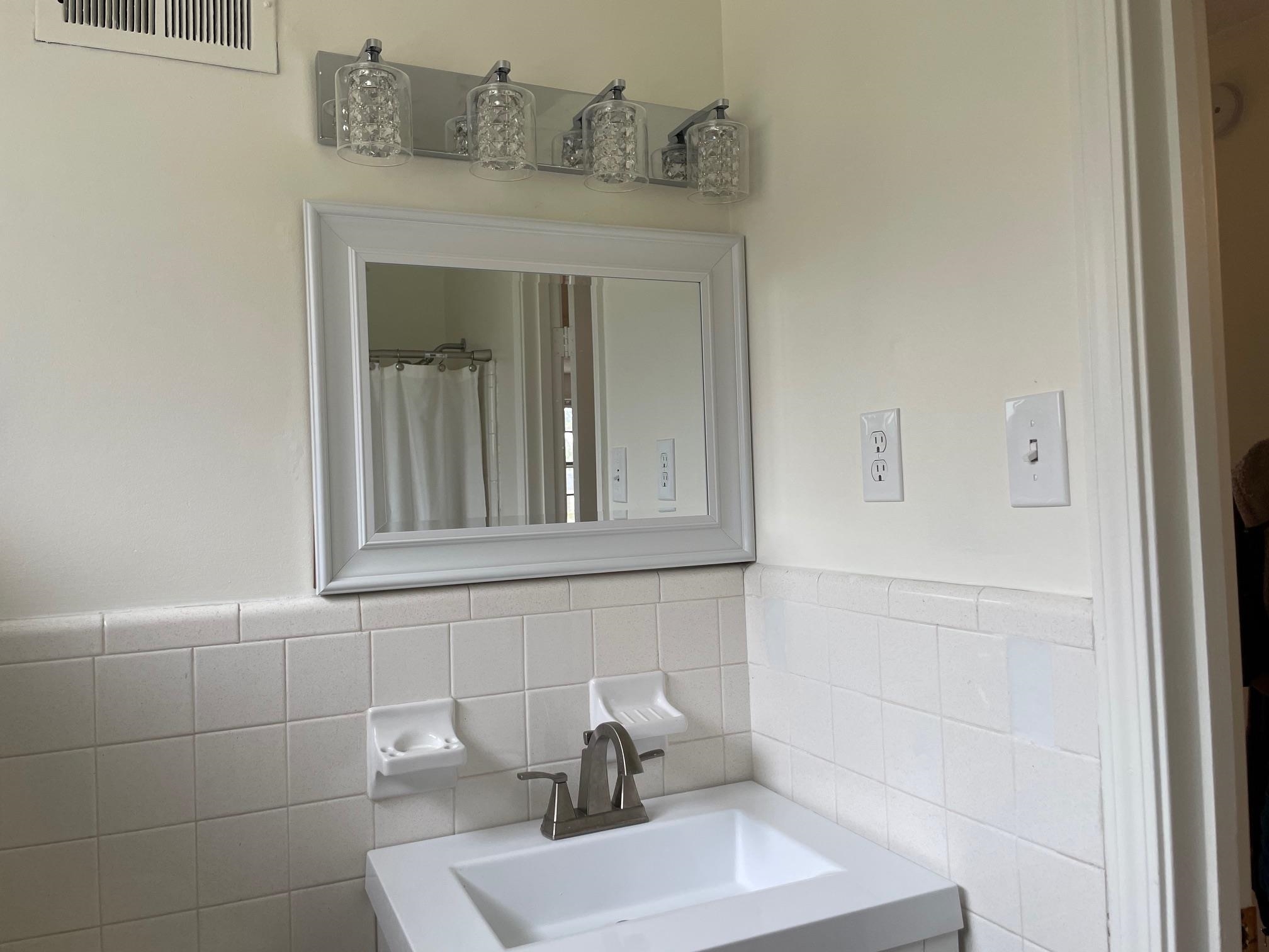 1898 Pennel Road Memphis, TN 38116 - Photo 25 of 34 a bathroom with a sink and mirror