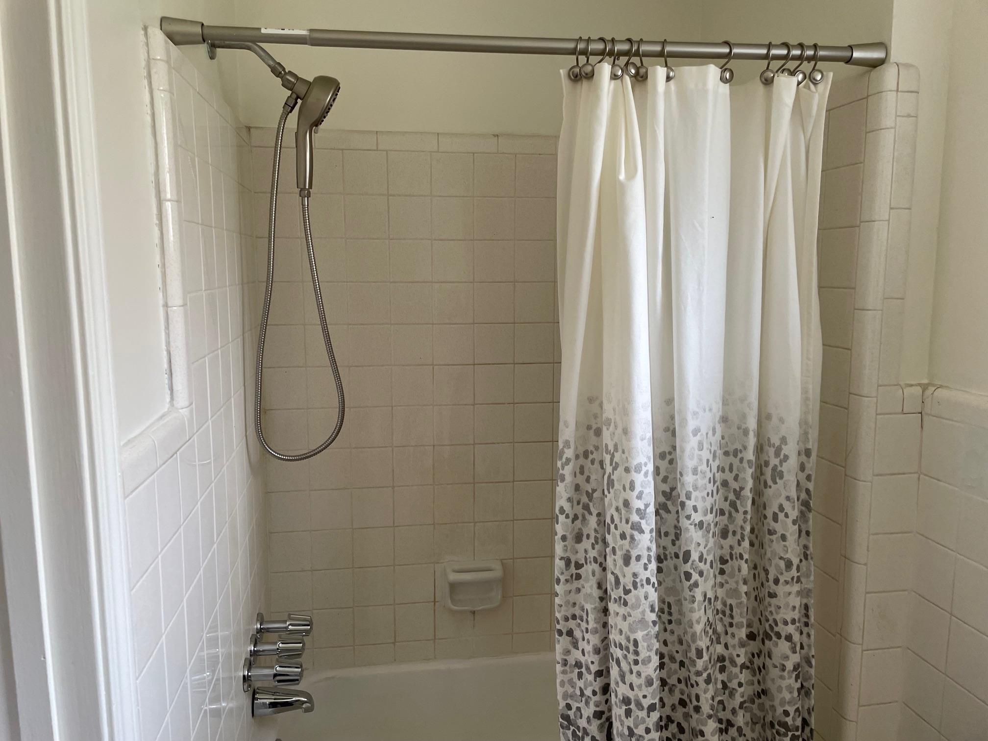 1898 Pennel Road Memphis, TN 38116 - Photo 26 of 34 a bathroom with a shower curtain and a window