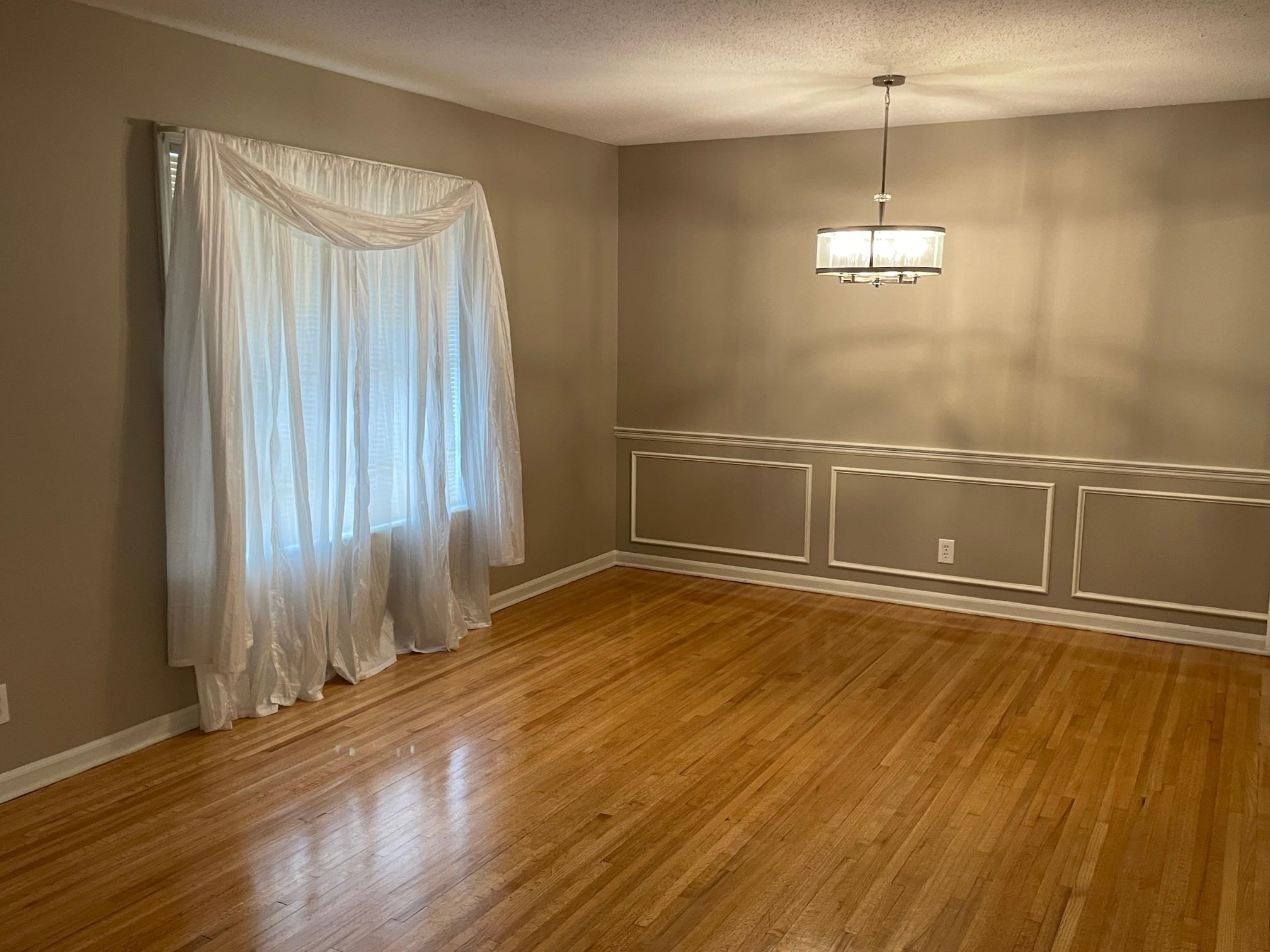 1898 Pennel Road Memphis, TN 38116 - Photo 4 of 34 a view of empty room with wooden floor and fan